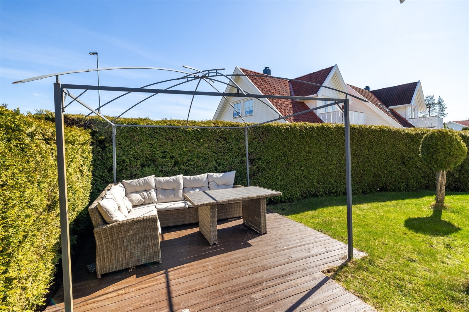 I hagen er det en terrasseplatting på ca. 8 m², omkranset av en hekk som skaper en usjenert og privat uteplass. Galleribilde