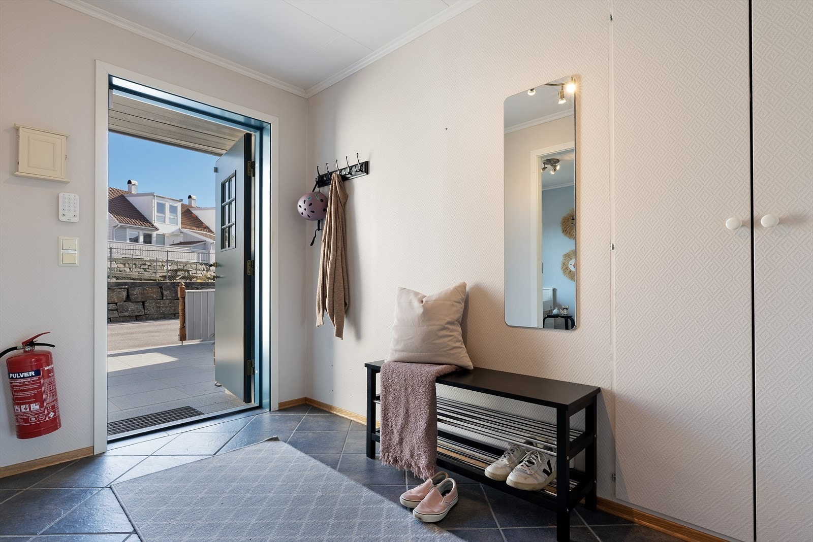Entréen har flislagt gulv og god plass til oppbevaring av yttertøy. Galleribilde