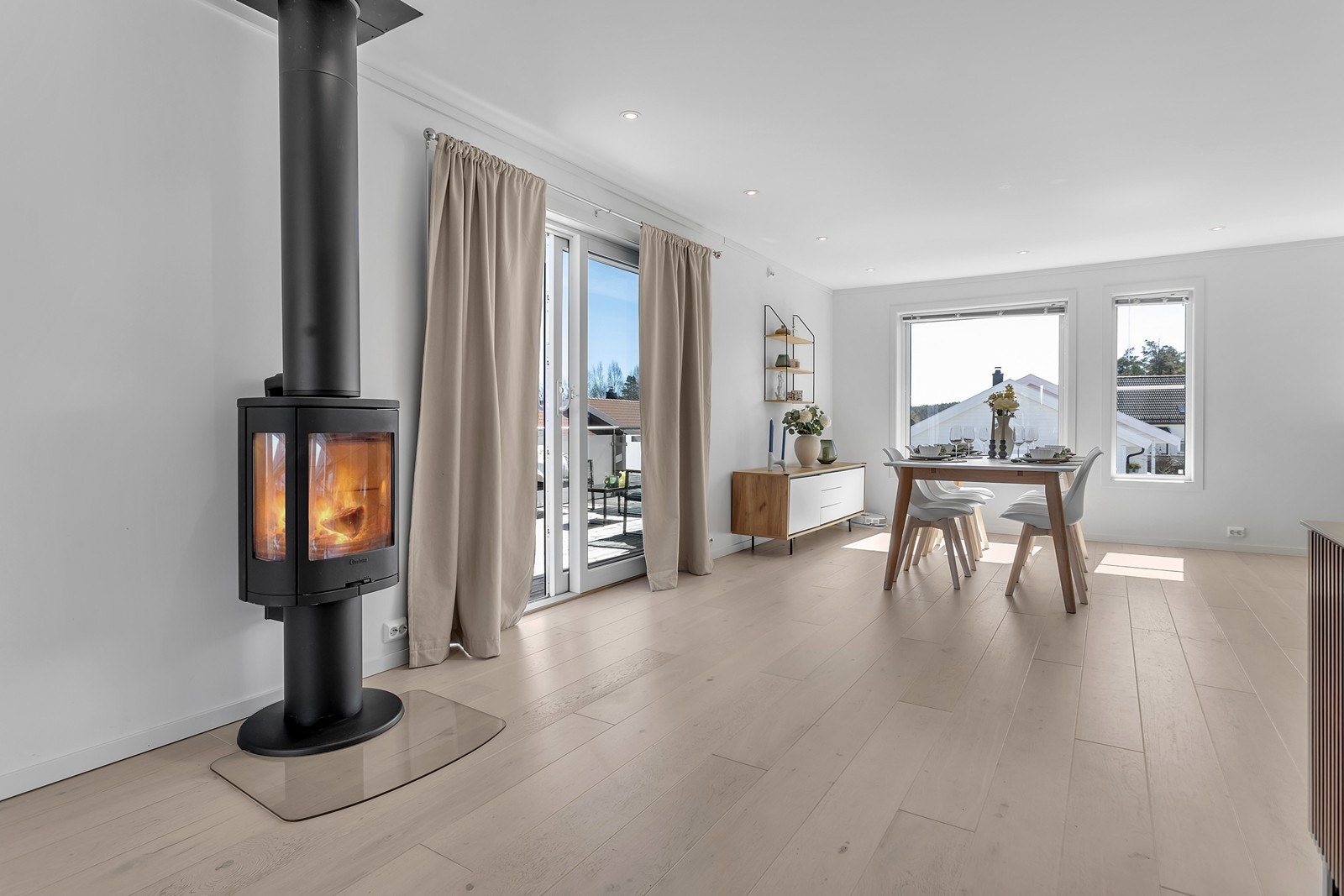I stuen er det peis som er med på å skape et behagelig inneklima. Her er også utgang til veranda. Galleribilde