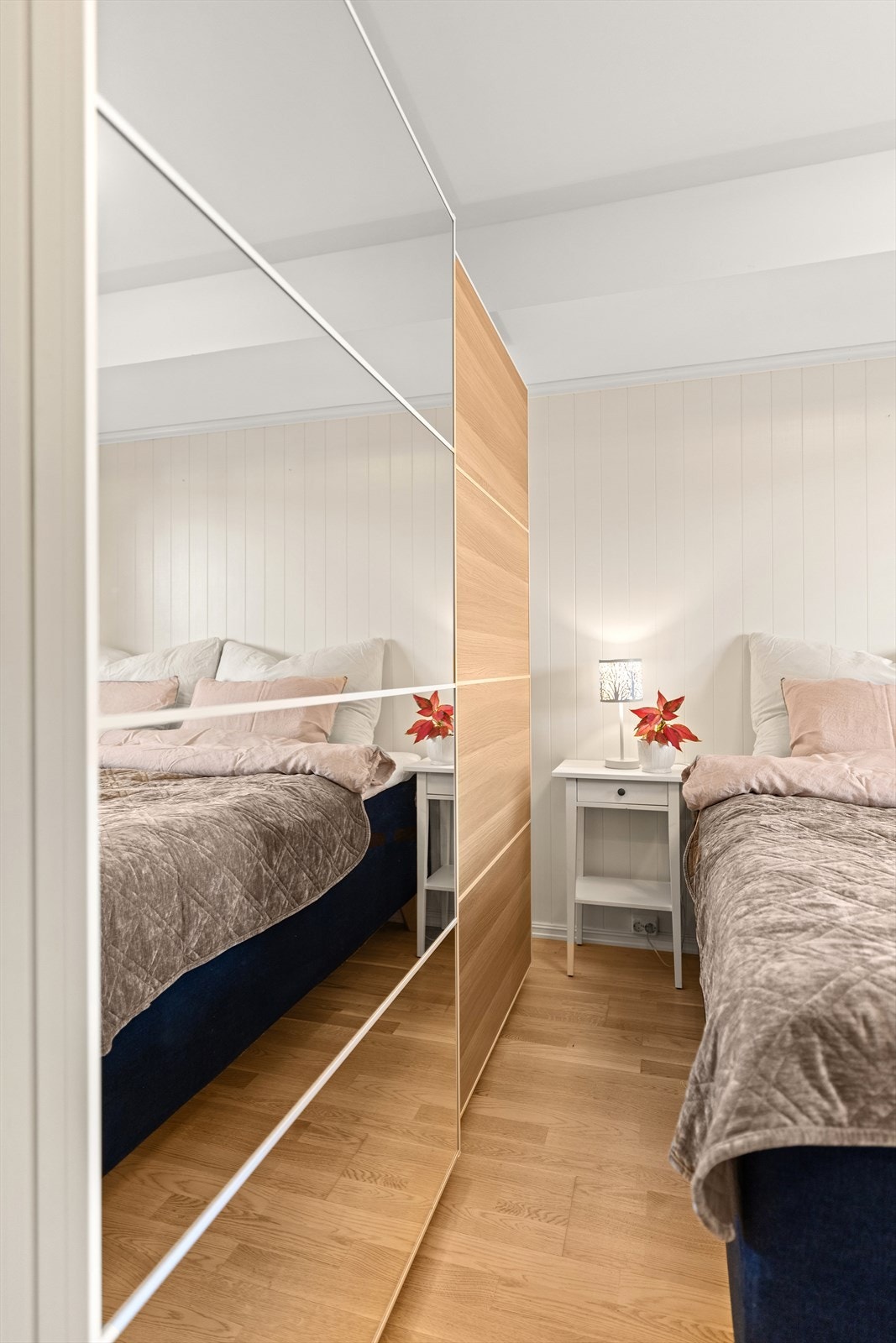 En stor skyvedørsgarderobe med speilfronter gir rikelig med oppbevaringsplass. Galleribilde