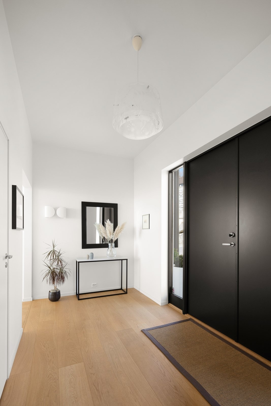 En lys og innbydende entré med gjennomgående parkett ønsker deg velkommen inn. Galleribilde