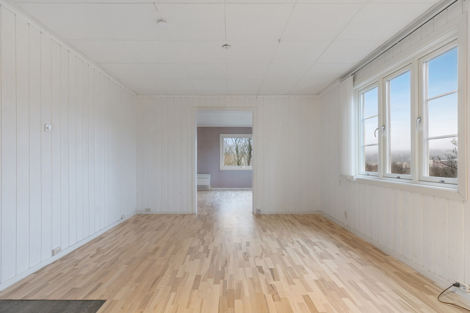 Lys stue med panel på vegger, parkettgulv - nyt utsikten! Galleribilde