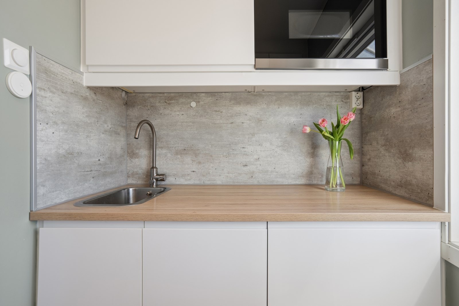 Praktiske løsninger med laminat benkeplate, Kitchenboard på veggen og installert vannstoppsystem for ekstra trygghet. Galleribilde