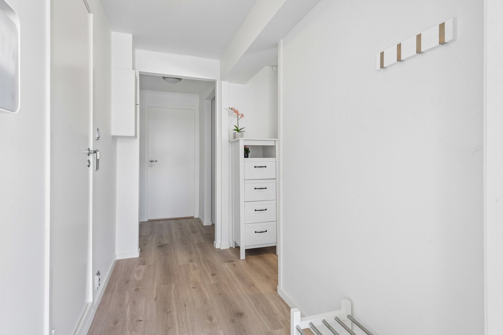 Lys og innbydende gang med plass til å henge fra seg klær og sette sko. Galleribilde