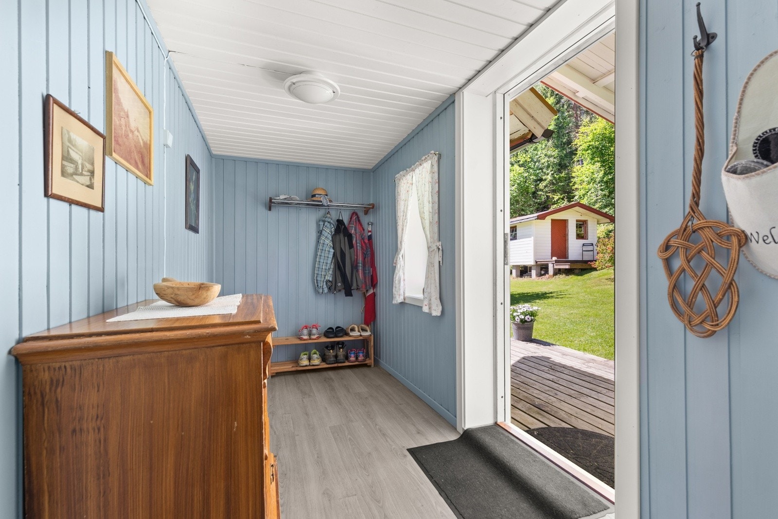 Innbydende og romslig entré, malt i en herlig lyseblå farge. Hytta oppleves romslig og preges av glade sommerfarger på veggene. Galleribilde