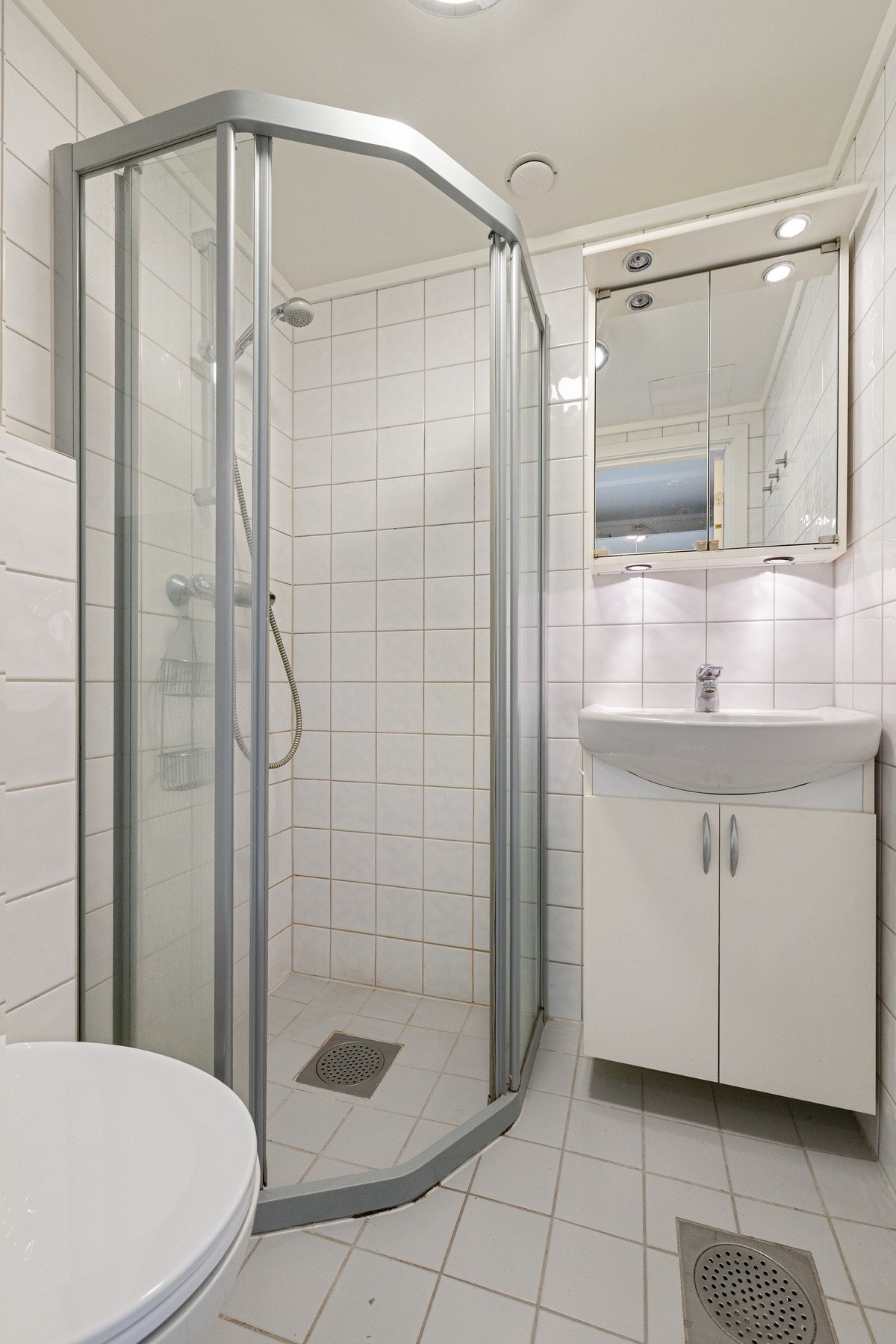 Flislagt bad med varmekabler i gulv fra 2008. Badet er innredet med servantseksjon med skap og overskap med speilfronter. Galleribilde
