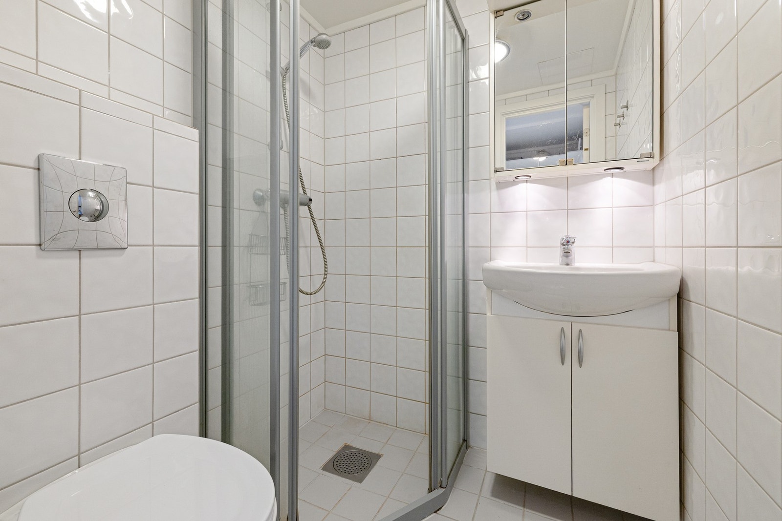 Badet har dusjhjørne med inn-/utadslående dører i herdet glass samt vegghengt toalett. Varmvannsberederen er defekt og vil bli byttet før overtagelse. Galleribilde