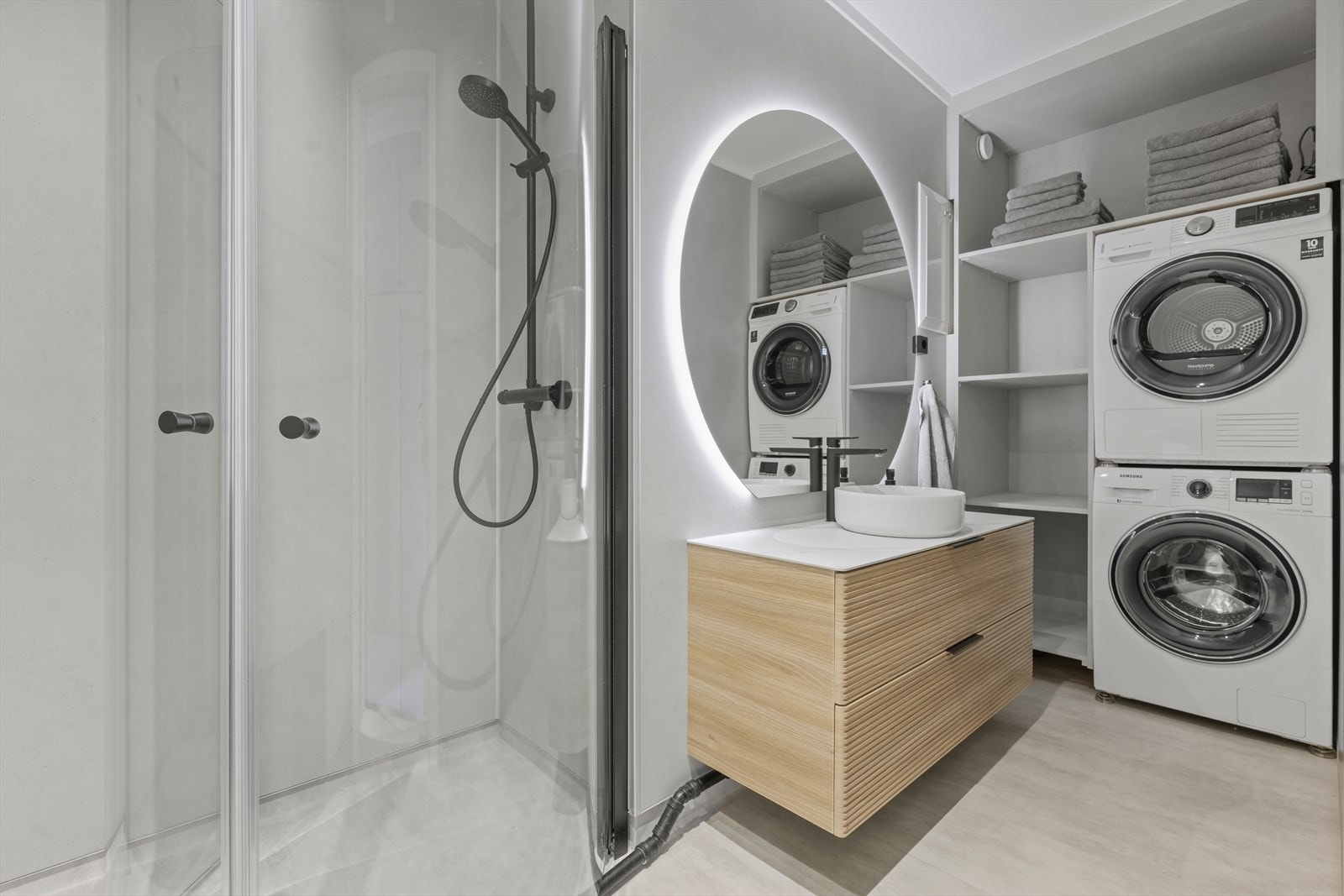 Badet er modernisert i 2024 og har våtromsplater på vegger og vinylbelegg på gulvet. Rundt vaskemaskinen er det etablert hyller for praktisk oppbevaring. Galleribilde