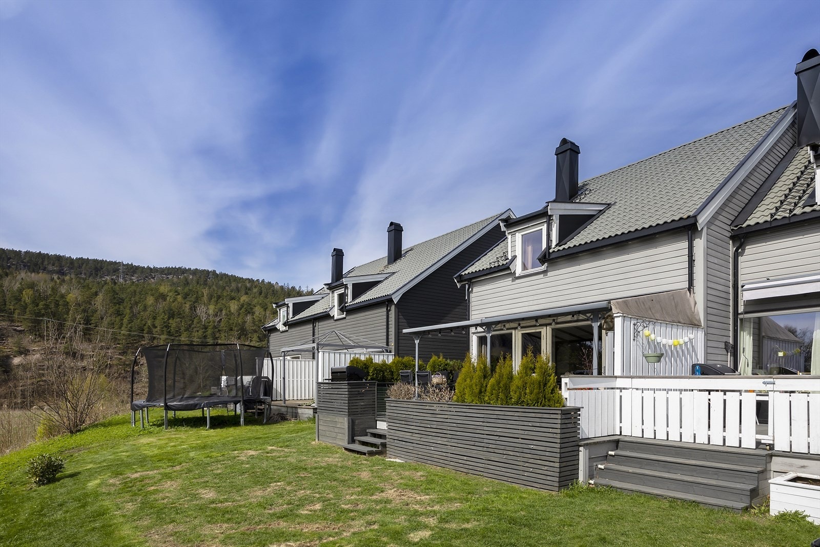 Hageside med terrasse, levegg og grøntareal utenfor boligen Galleribilde