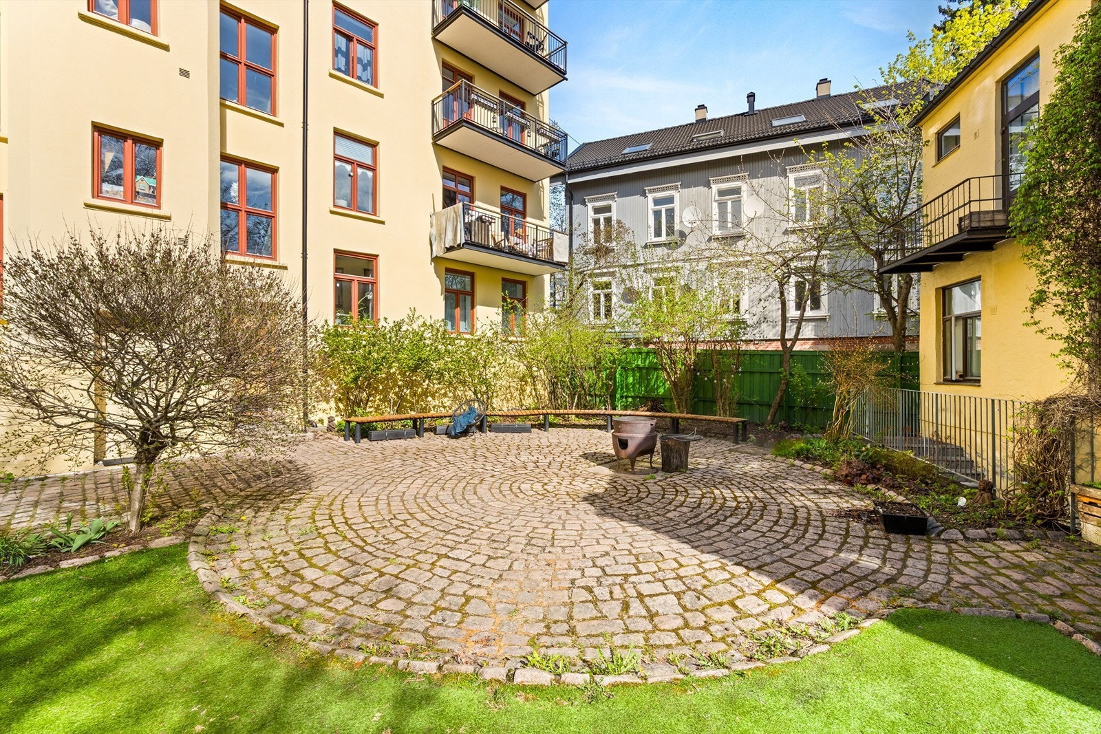 Fellesarealene er pent opparbeidet med en kombinasjon av steinbelagte soner og gressplen. Galleribilde