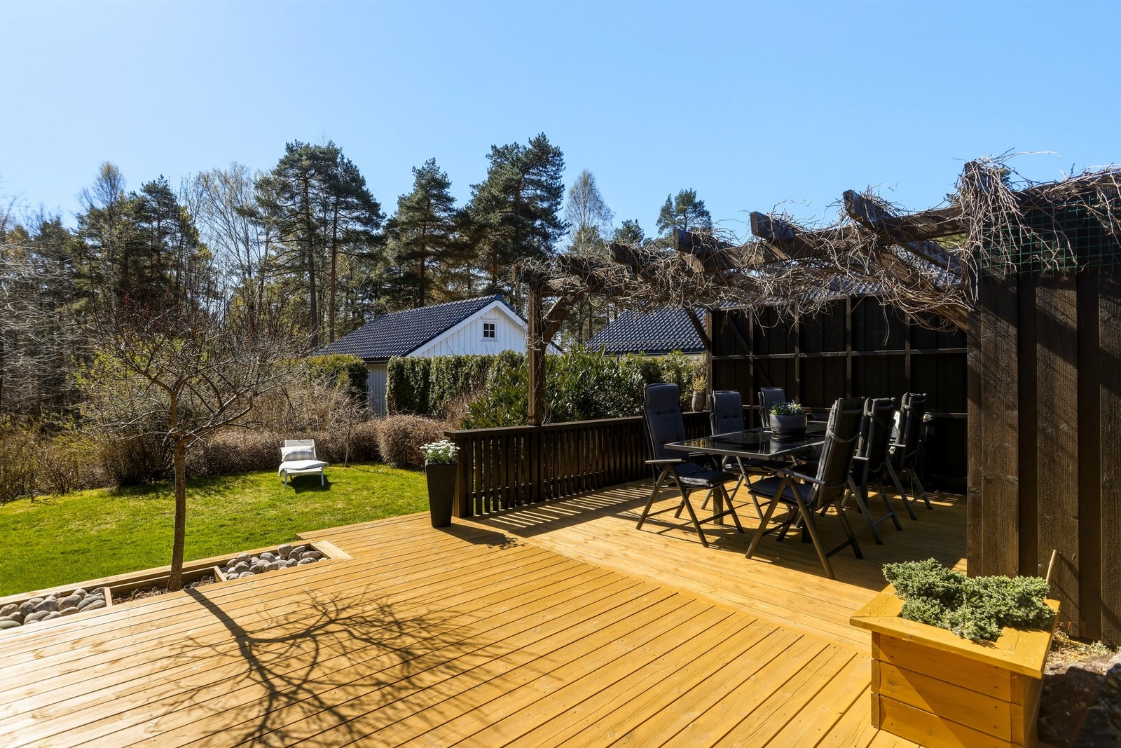 Romslig terrasse med pergola, utsikt mot hage og skog. Solrik beliggenhet og god plass til utemøbler. Galleribilde
