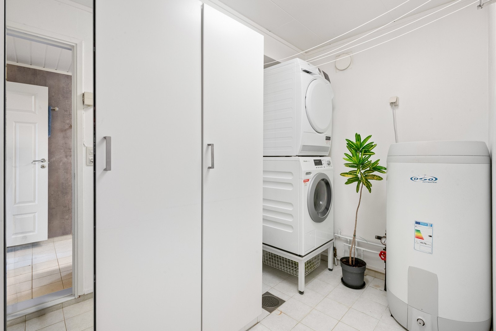 Vaskerom med inngang fra badet - gode oppbevaringsmuligheter med flere garderobeskap Galleribilde