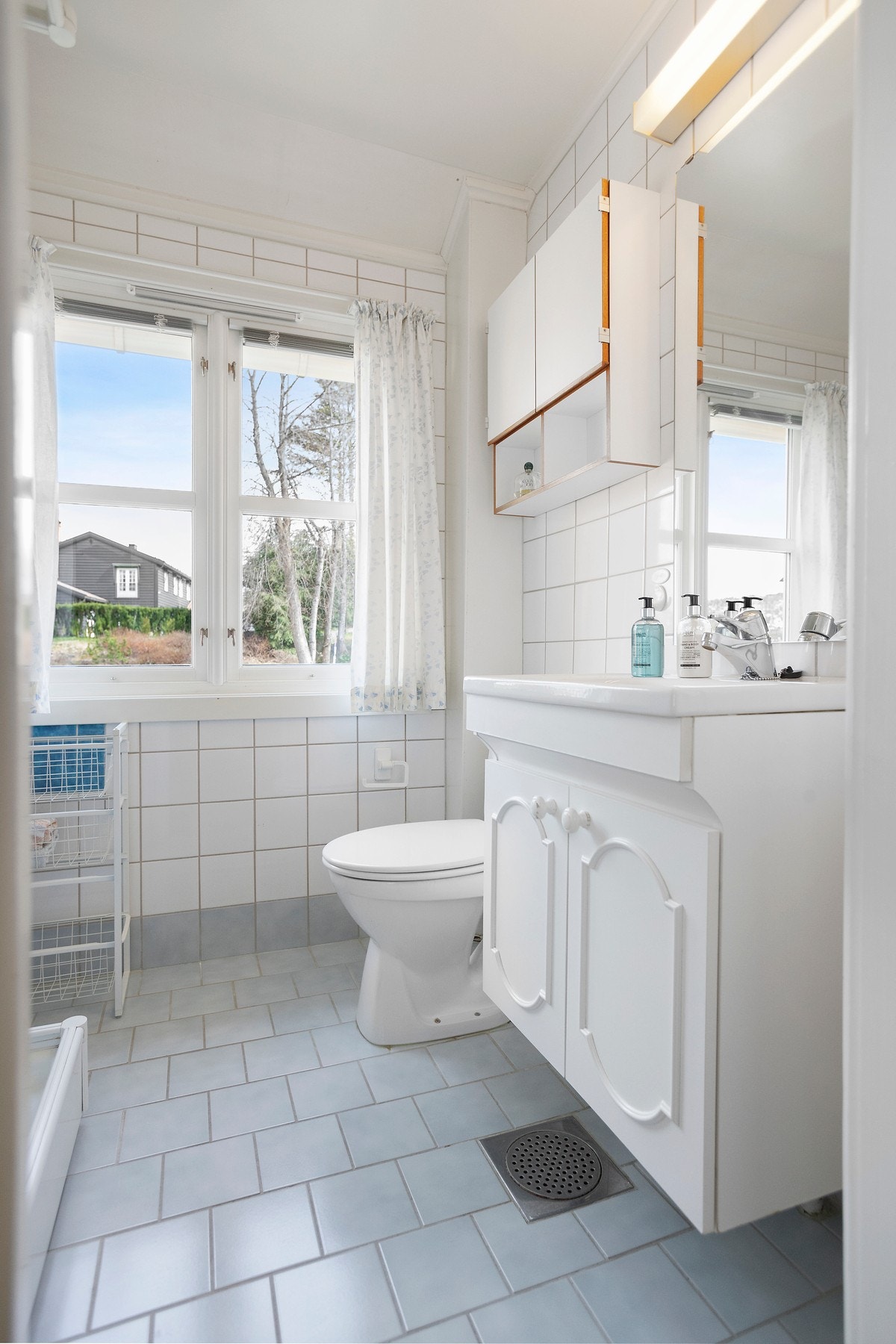 Badet er flislagt og har baderomsinnredning med profilerte fronter, speil med overlys. Galleribilde