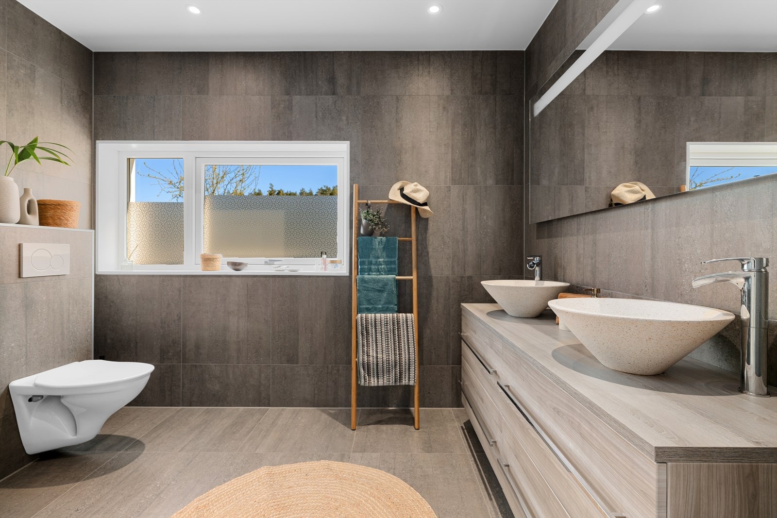 Det delikate badet er flislagt med store fliser på vegger og gulv. Galleribilde