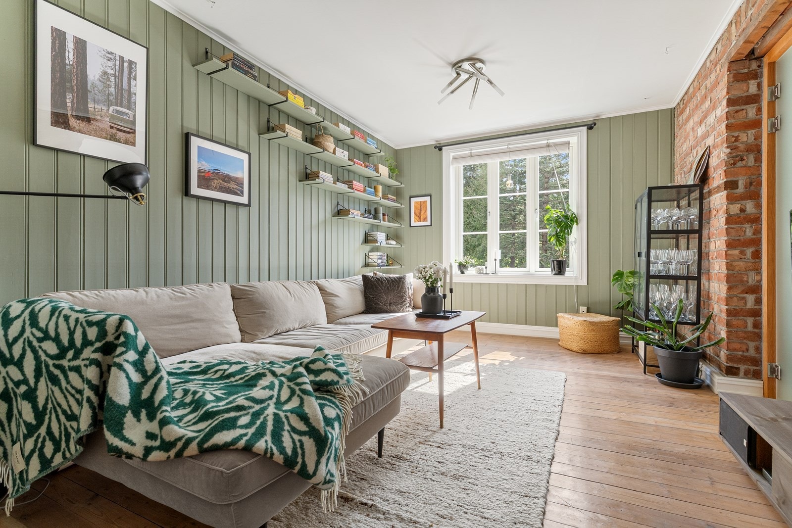 Rommet er romslig og har plass til både sofa, TV-oppsett og tilhørende møbler, noe som gjør det til et allsidig rom. Galleribilde