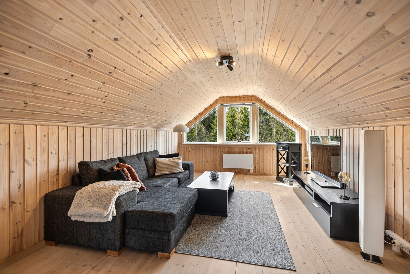 Lun og romslig loftstue med sjarmerende skråtak og store vindusflater som slipper inn rikelig med naturlig lys. Galleribilde