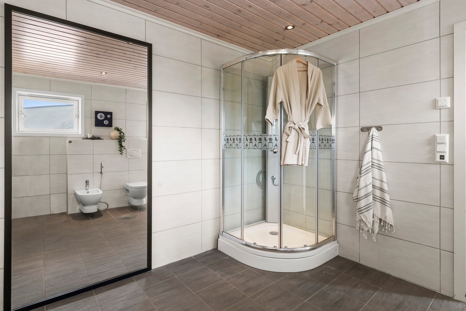Badet er flislagt med downlights i himlingen. Galleribilde