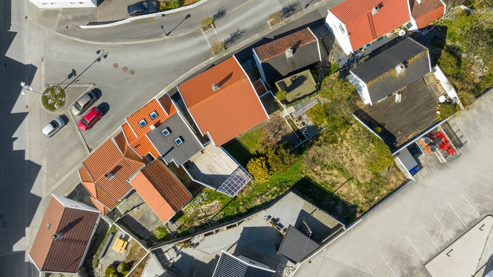 Tomten er opparbeidet med skiferbelagt terrasse, samt noe beplantning og plen mot nord (tomtegensen er omtrentlig inntegnet, avvik kan forekomme) Galleribilde