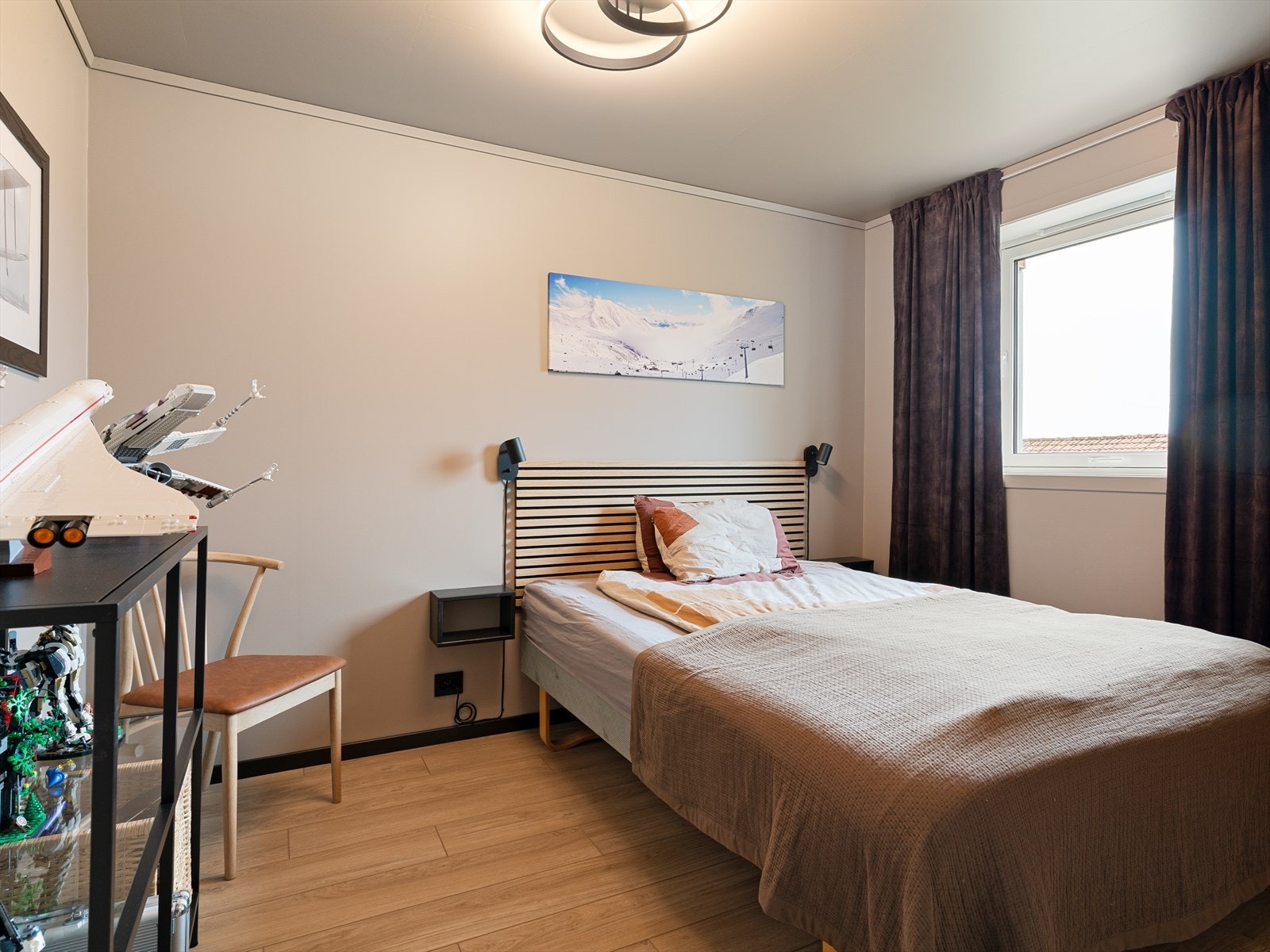 Soverom i underetasjen med moderne overflater. Huset har totalt fire soverom, fordelt med to på hvert plan. Galleribilde