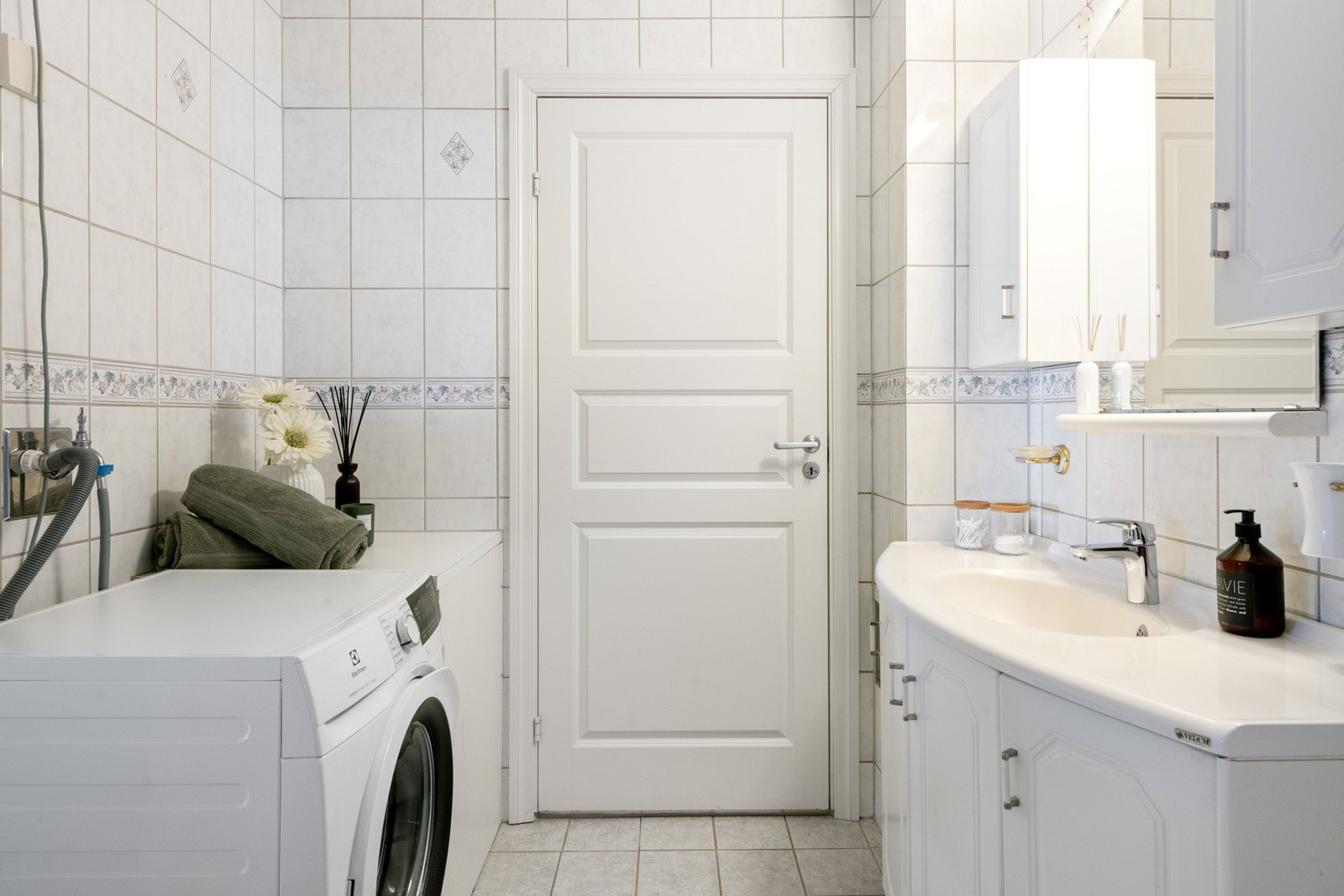 Badet har opplegg for vaskemaskin. Innkasset varmtvannstank i hjørnet. Galleribilde