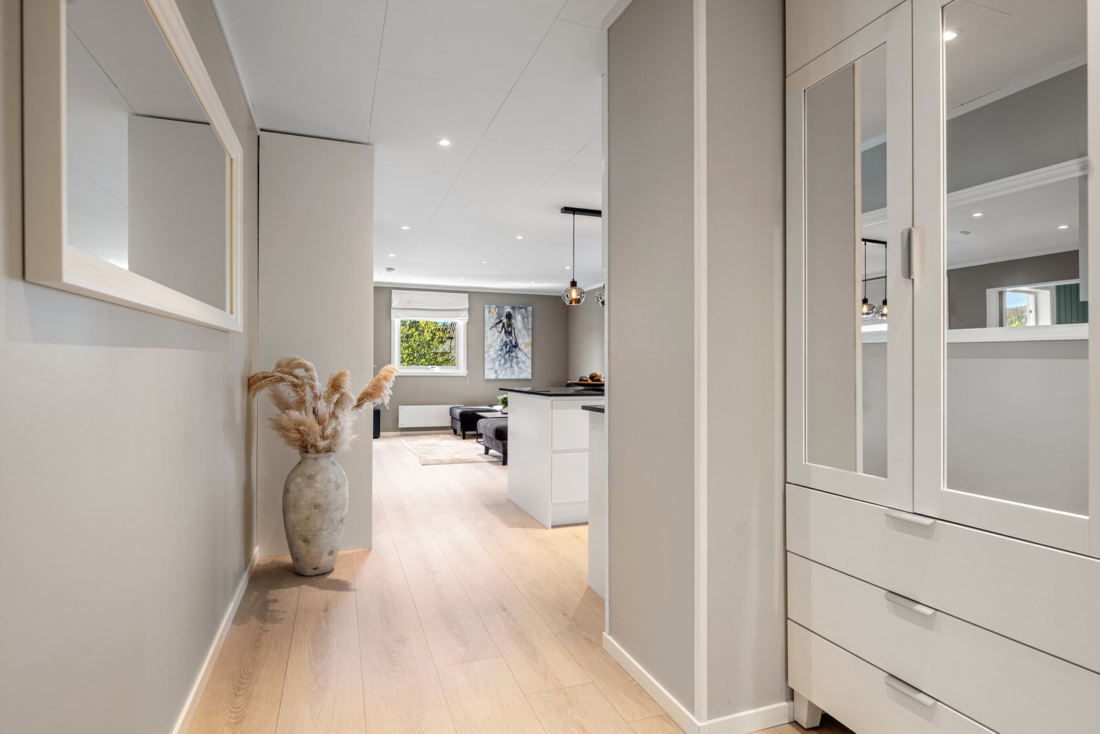 Fra gangen åpner det seg en innbydende sightline rett inn mot det flotte kjøkkenet og stuen. Galleribilde