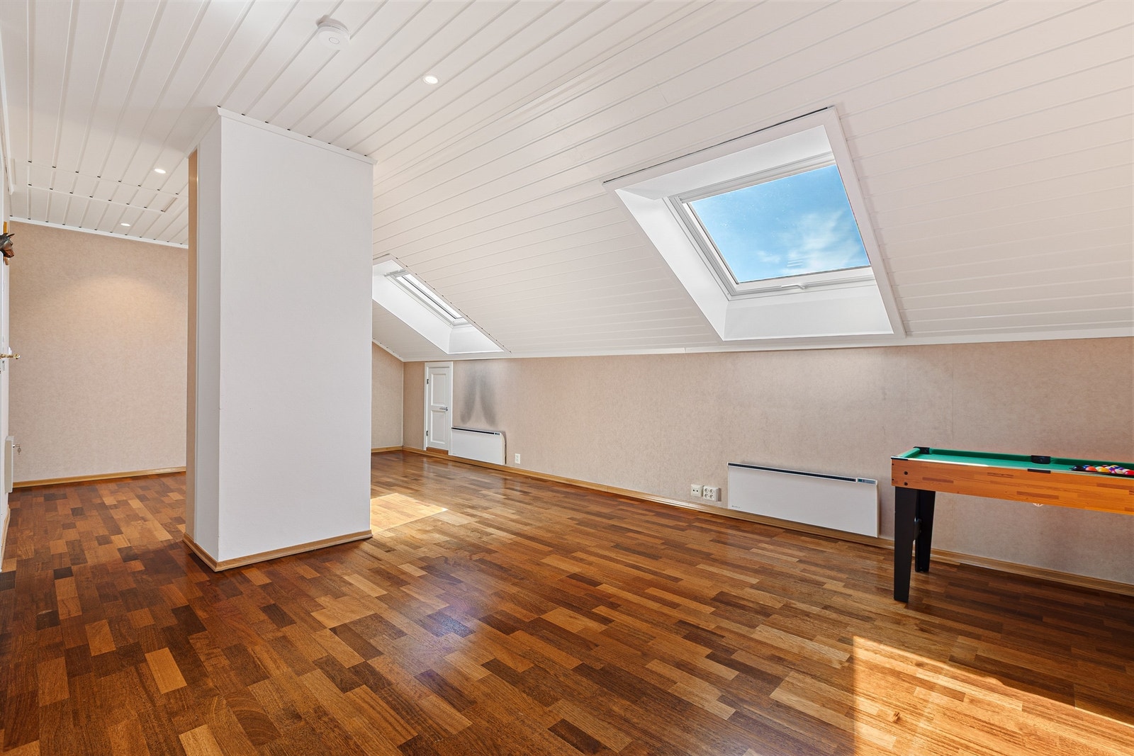 Den romslige loftstuen gir rikelig med ekstra plass. Gulvet er kledd med tre-stavs parkett. Galleribilde