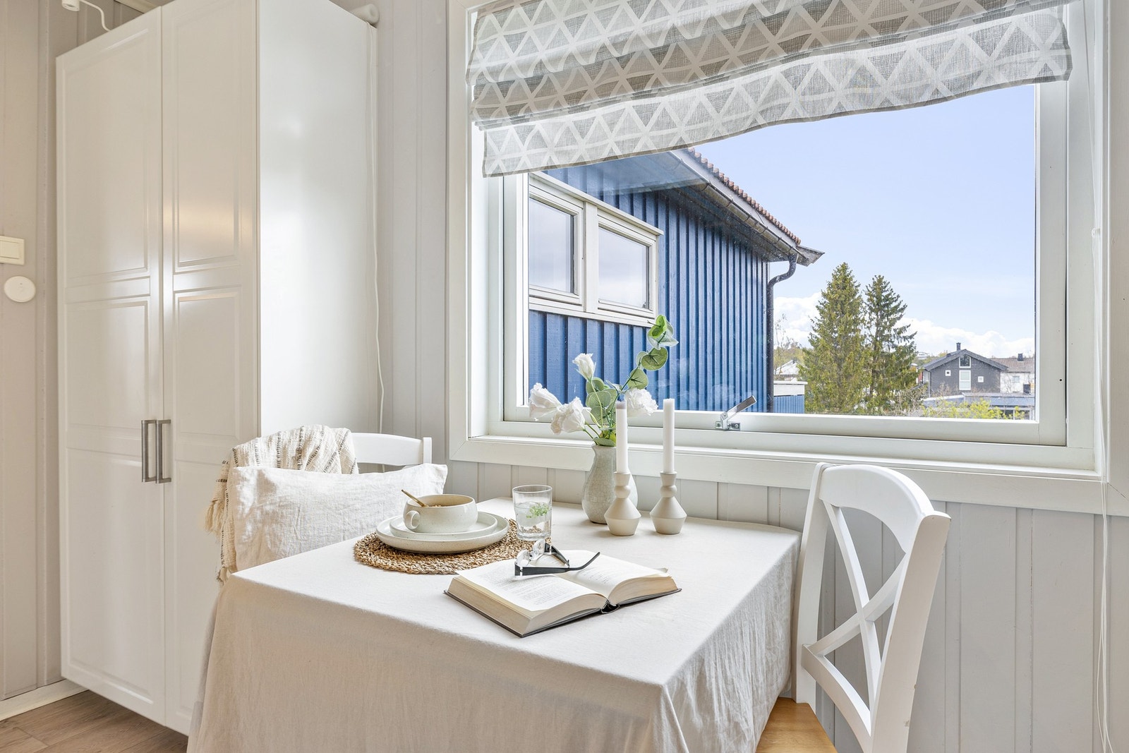 Kjøkkenet har plass til et koselig spisebord ved vinduet. Galleribilde