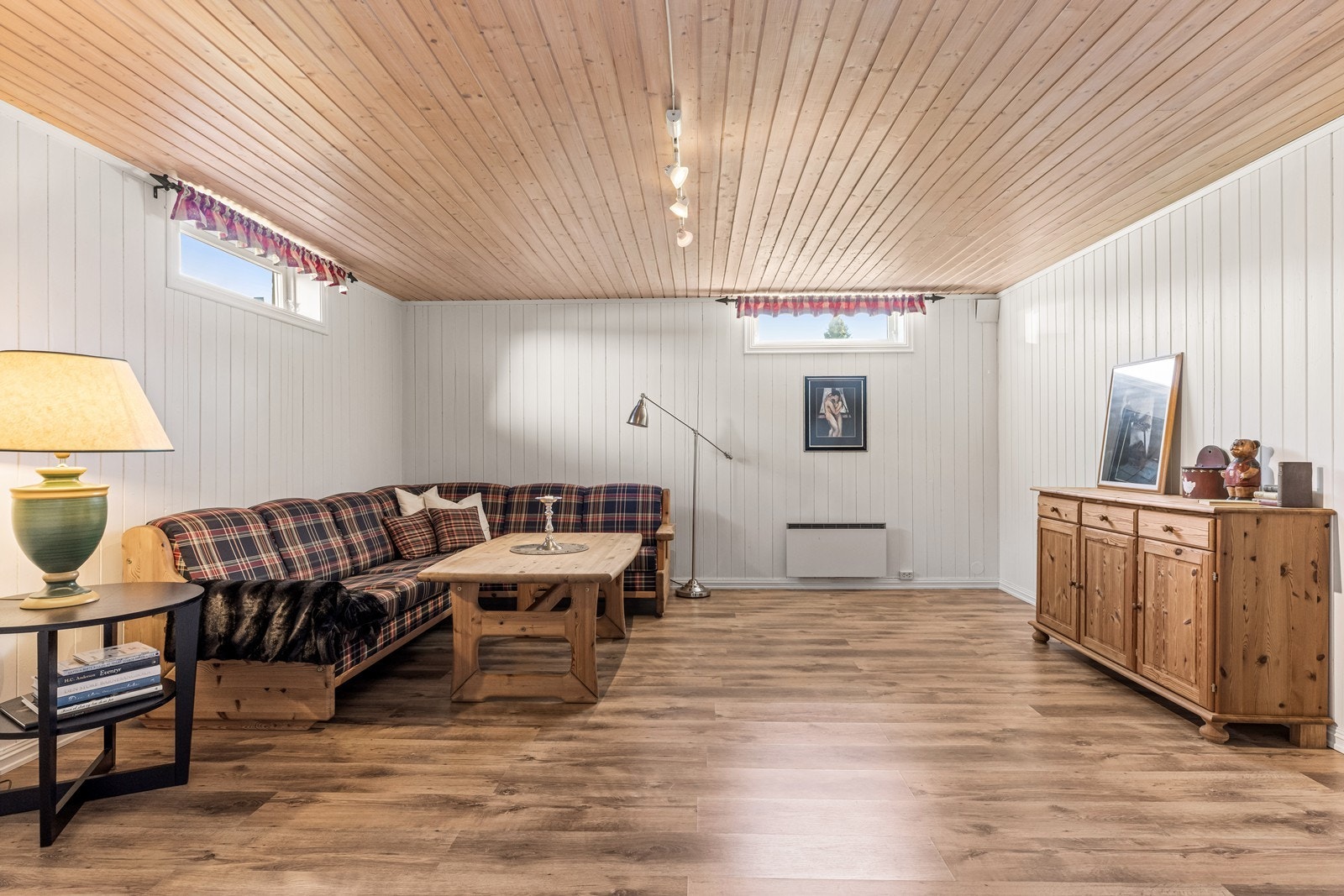 Kjellerstuen har laminatgulv og panel på veggene, som gir et slitesterkt og vedlikeholdsvennlig interiør. Galleribilde