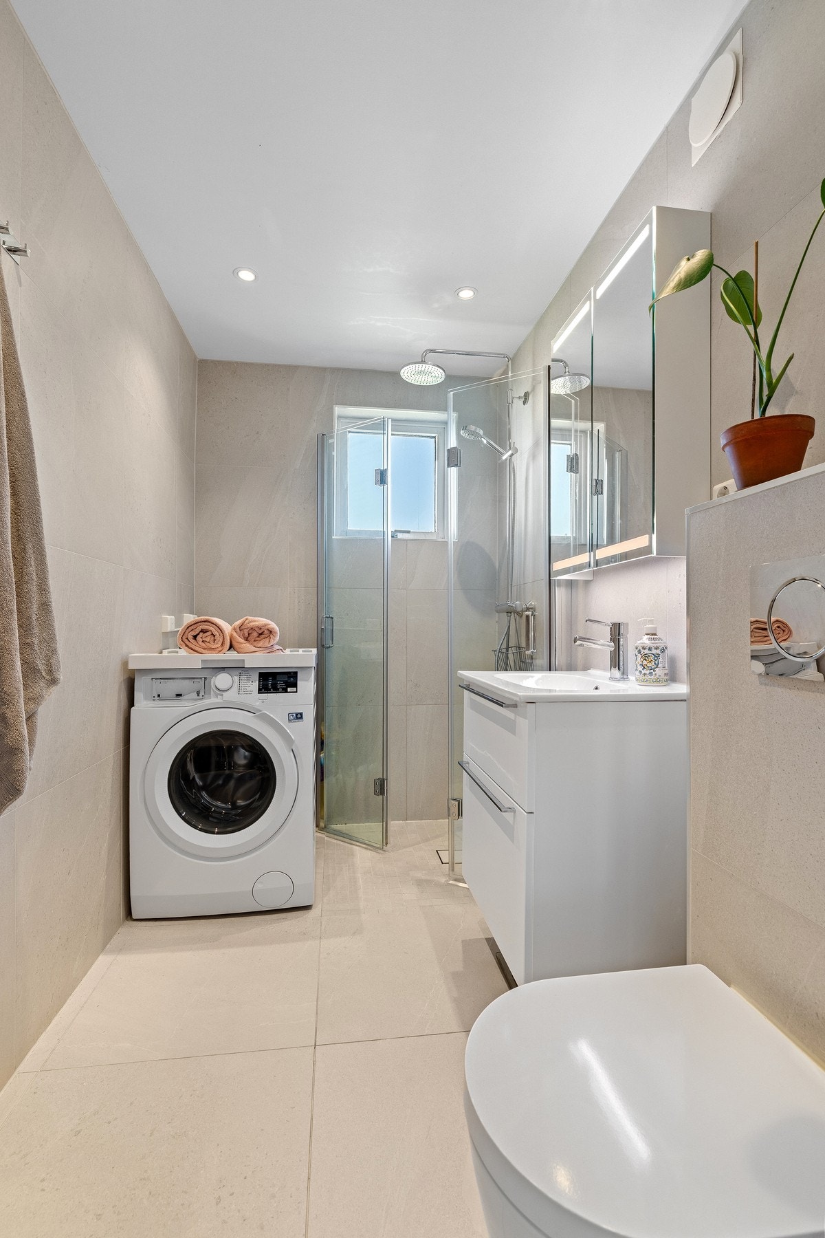 Badet har opplegg for vaskemaskin og plass til tørketrommel. Galleribilde