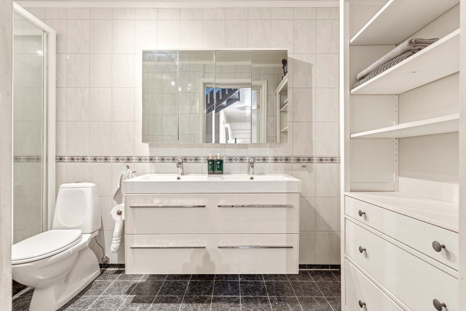 Badet i underetasjen har baderomsplater på vegger og flislagt gulv med varmekabler. Galleribilde