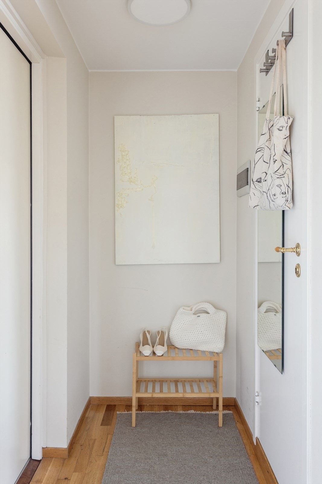 Entré med vegger malt i beige toner som gir et rolig og lunt førsteinntrykk. Her er det god plass til både sko og klesoppheng. Galleribilde