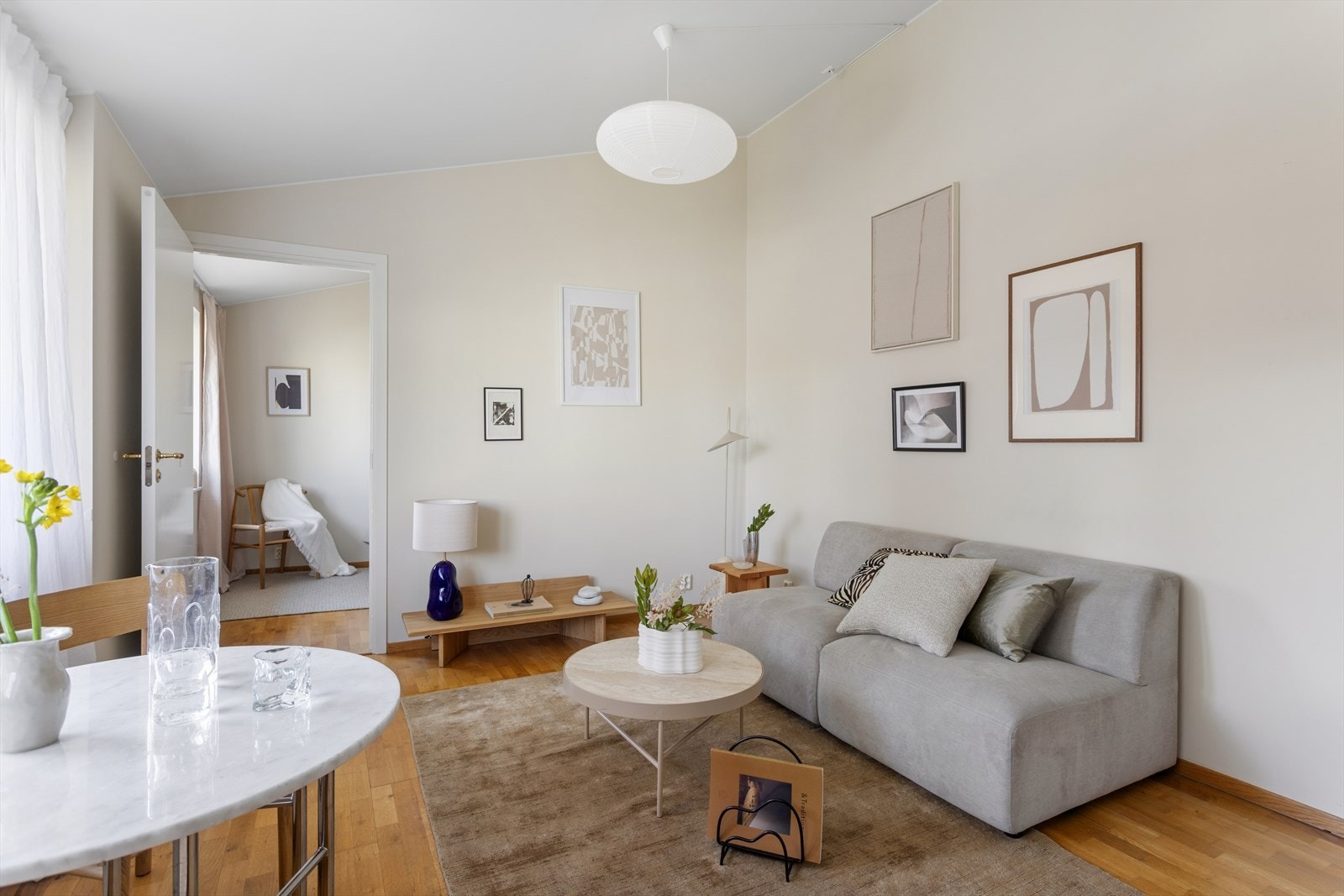Stuen har en naturlig og fleksibel møblering med god plass til både sofagruppe og spisebord, noe som gjør det enkelt å skape en hyggelig sone for både avslapning og måltider. Galleribilde
