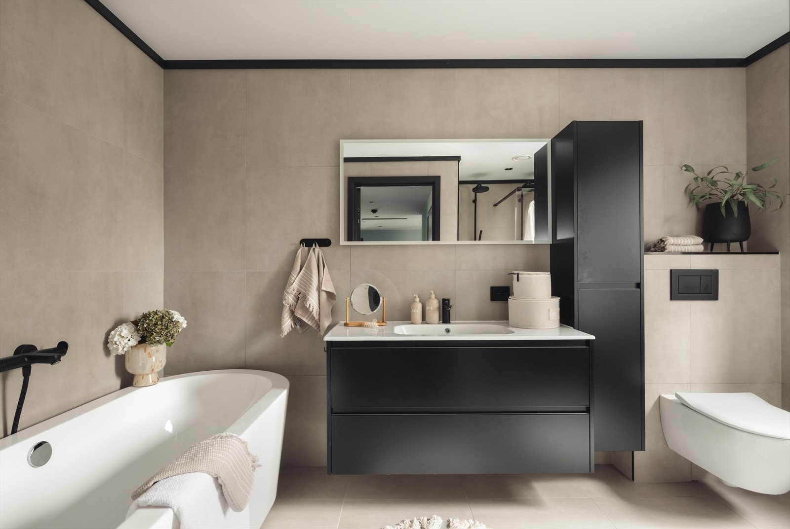 Badet fremstår som eksklusivt og delikat, med flislagte overflater og vannbåren varme i gulv som gir høy komfort. Galleribilde