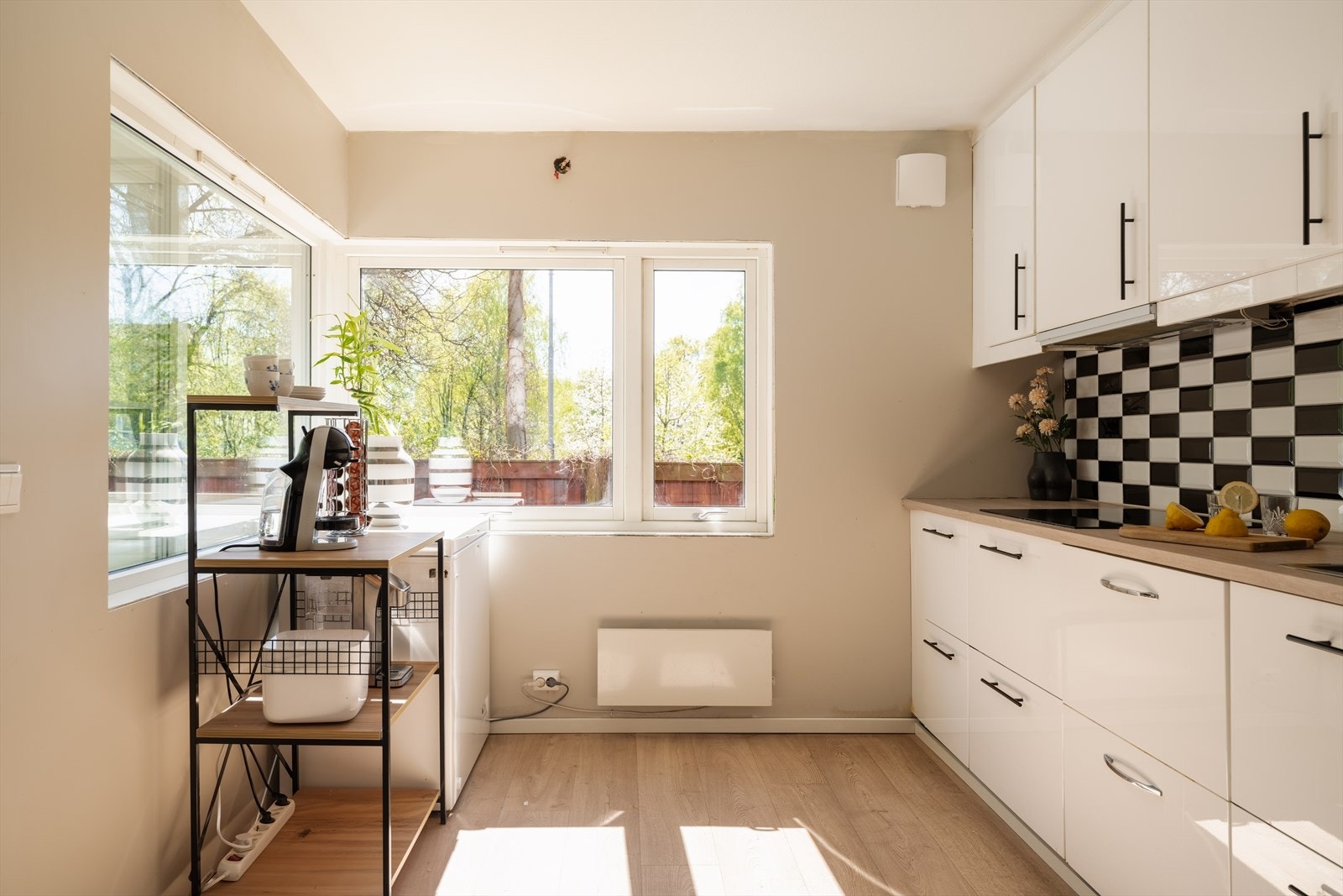 Kjøkkenet har store vindusflater og god plass til et frokostbord Galleribilde