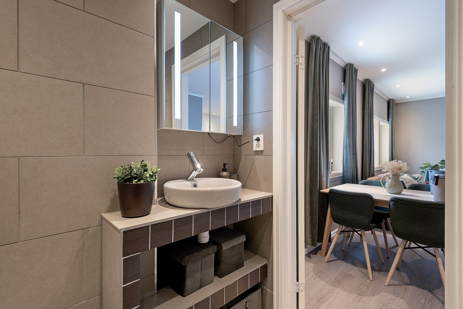 Flislagte vegger og moderne servant gir et stilrent uttrykk på badet. Galleribilde