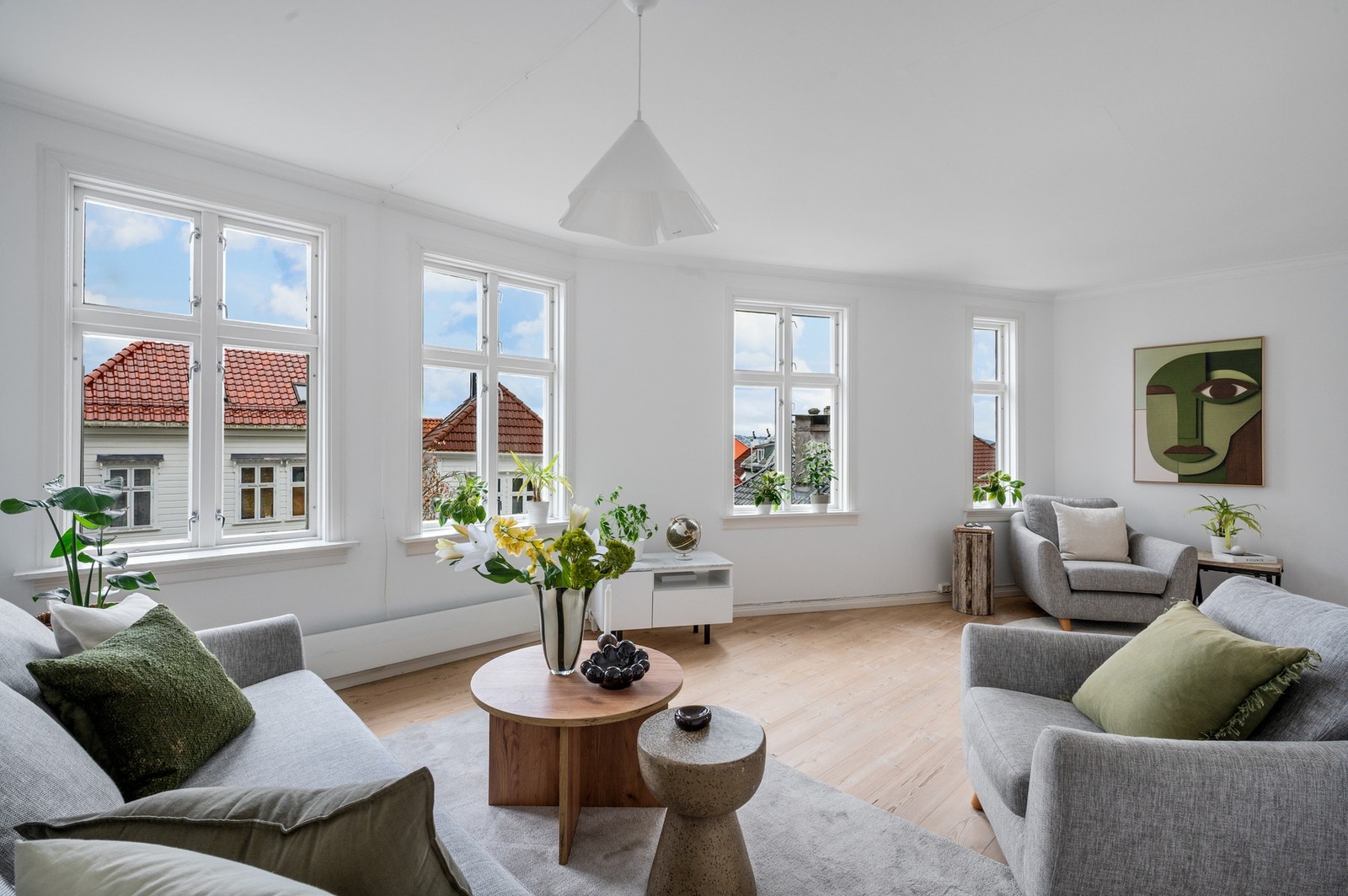 Stuens mange vinduer gir rommet godt med naturlig lys Galleribilde