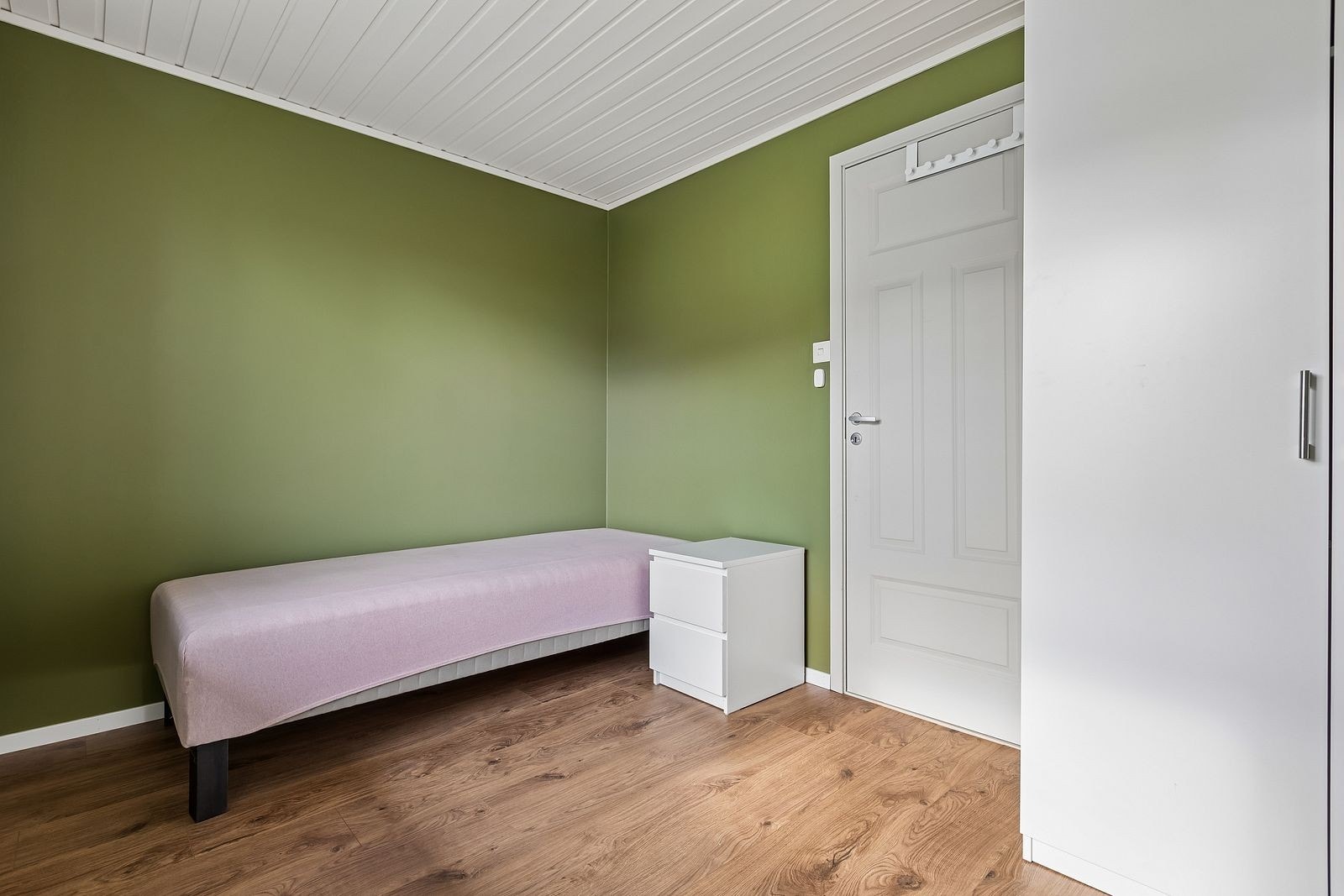 Pent soverom med laminat på gulv, og malte flater på vegg. Innredet med garderobeskap. Galleribilde