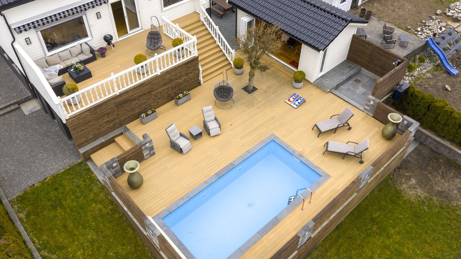 Mot vest er det et romslig og solrikt terrasseområde med både hagestue og oppvarmet svømmebasseng (hagestue og svømmebasseng med terrasse/levegger er per i dag ikke godkjent, se mer info i salgsoppgaven under punktet "Ferdigattest/brukstillatelse") Galleribilde