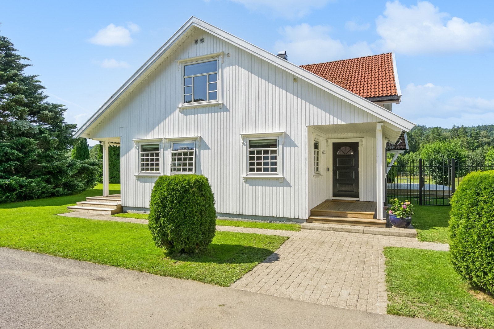 Velholdt og innbydende uteområde med pent opparbeidet hage og et hyggelig inngangsparti. Galleribilde