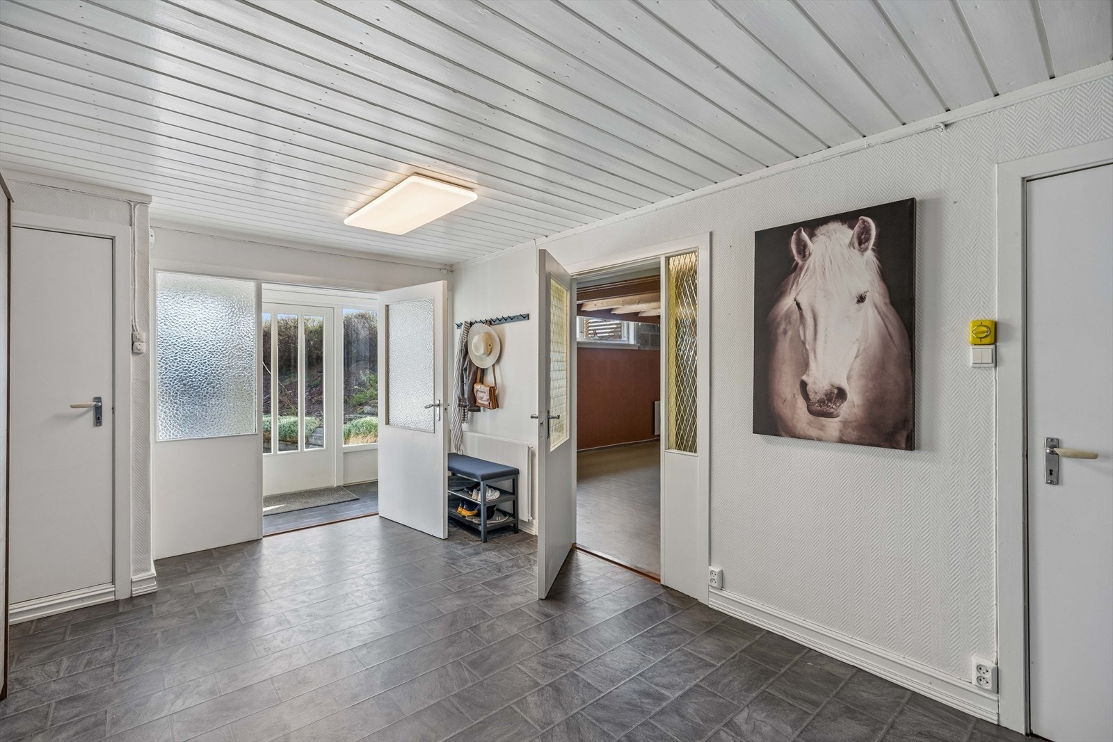 Fra hallen er det adkomst til WC-rom, vaskerom, boder og et innredet rom/stue. Galleribilde