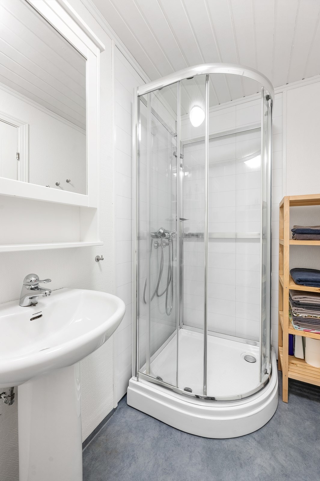 Badet er utstyrt med dusjkabinett, servant og toalett. Galleribilde
