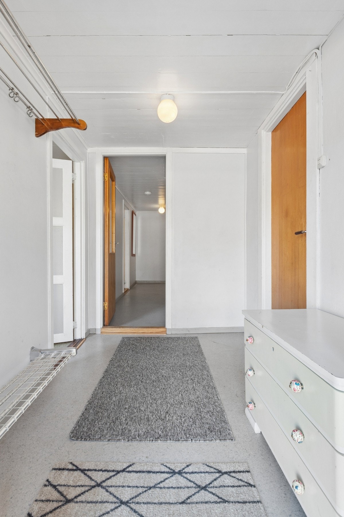 Entré med dør til vaskerom på høyre side og soverom på venstre side. Galleribilde