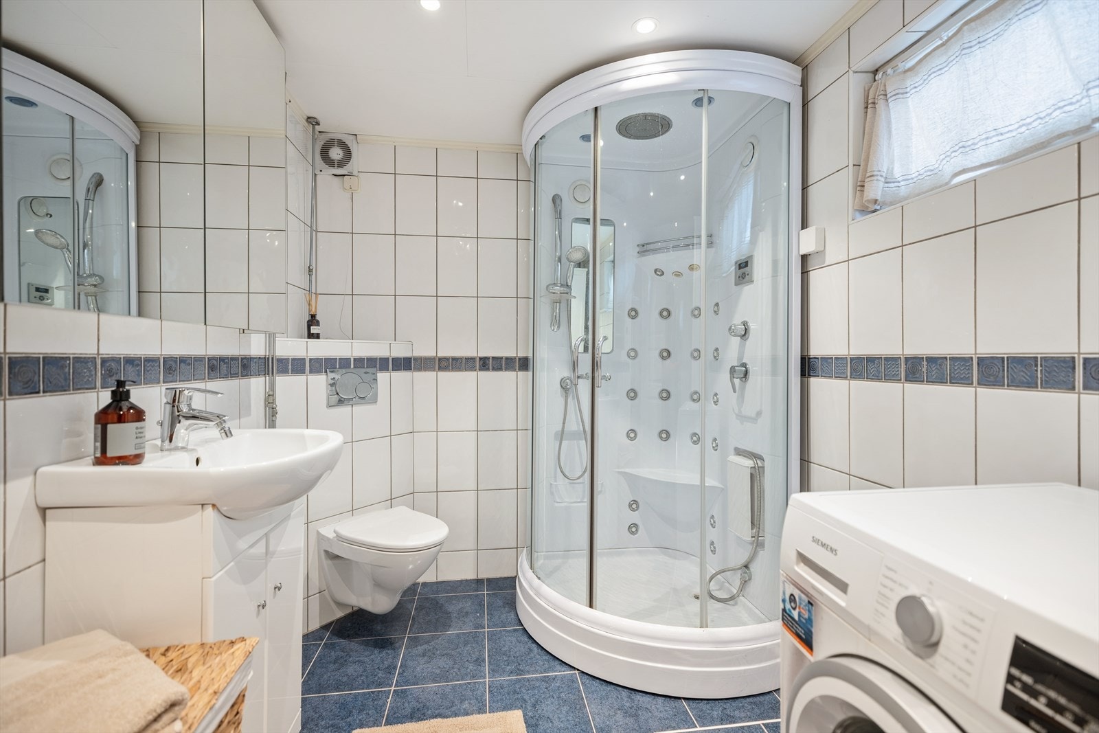 Badet er innredet med vegghengt toalett, dusjkabinett og servant med underskap. Våtrommet har behov for oppussing. Galleribilde