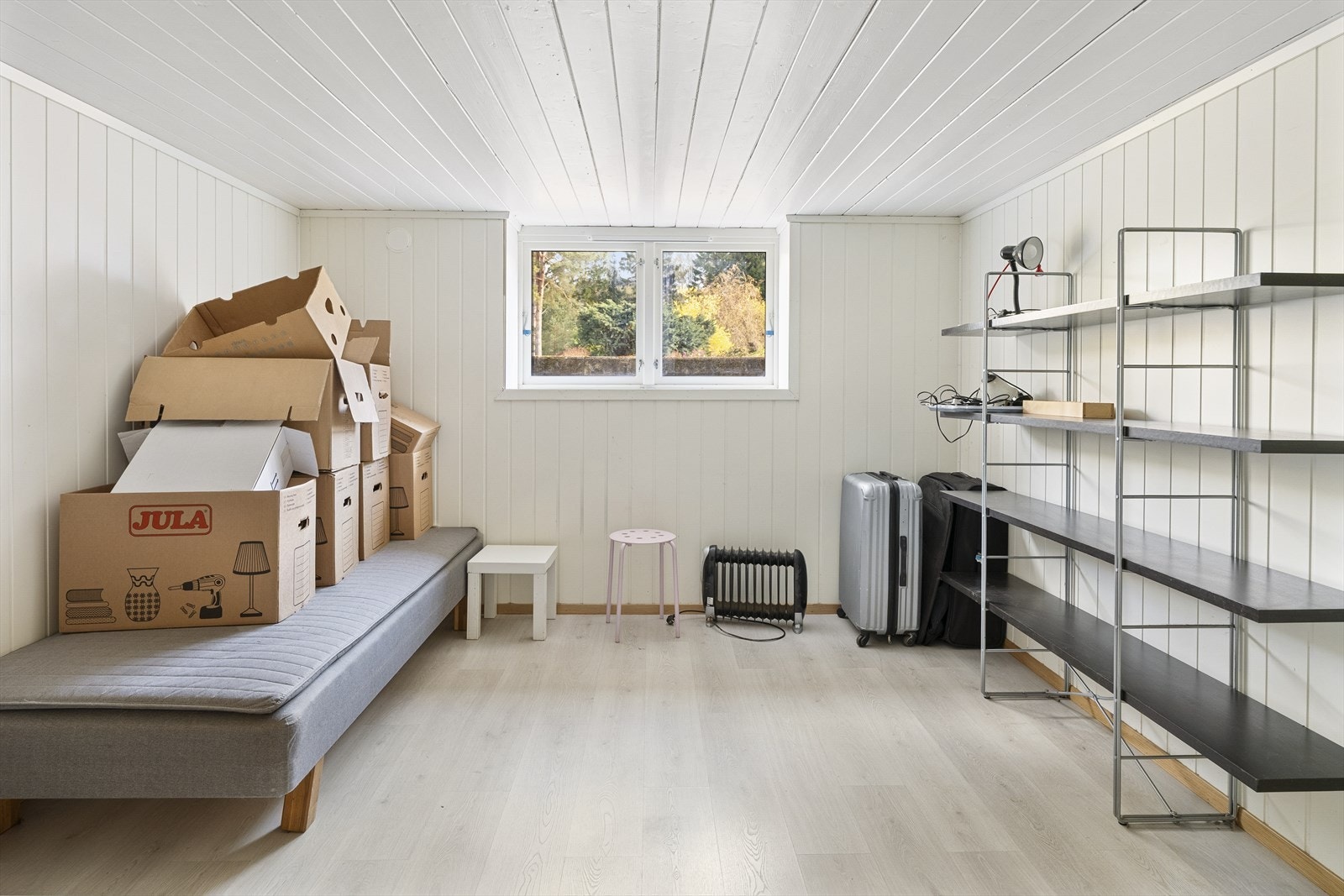 Innredet rom i kjelleren med laminatgulv og panel på vegger og i tak. Galleribilde
