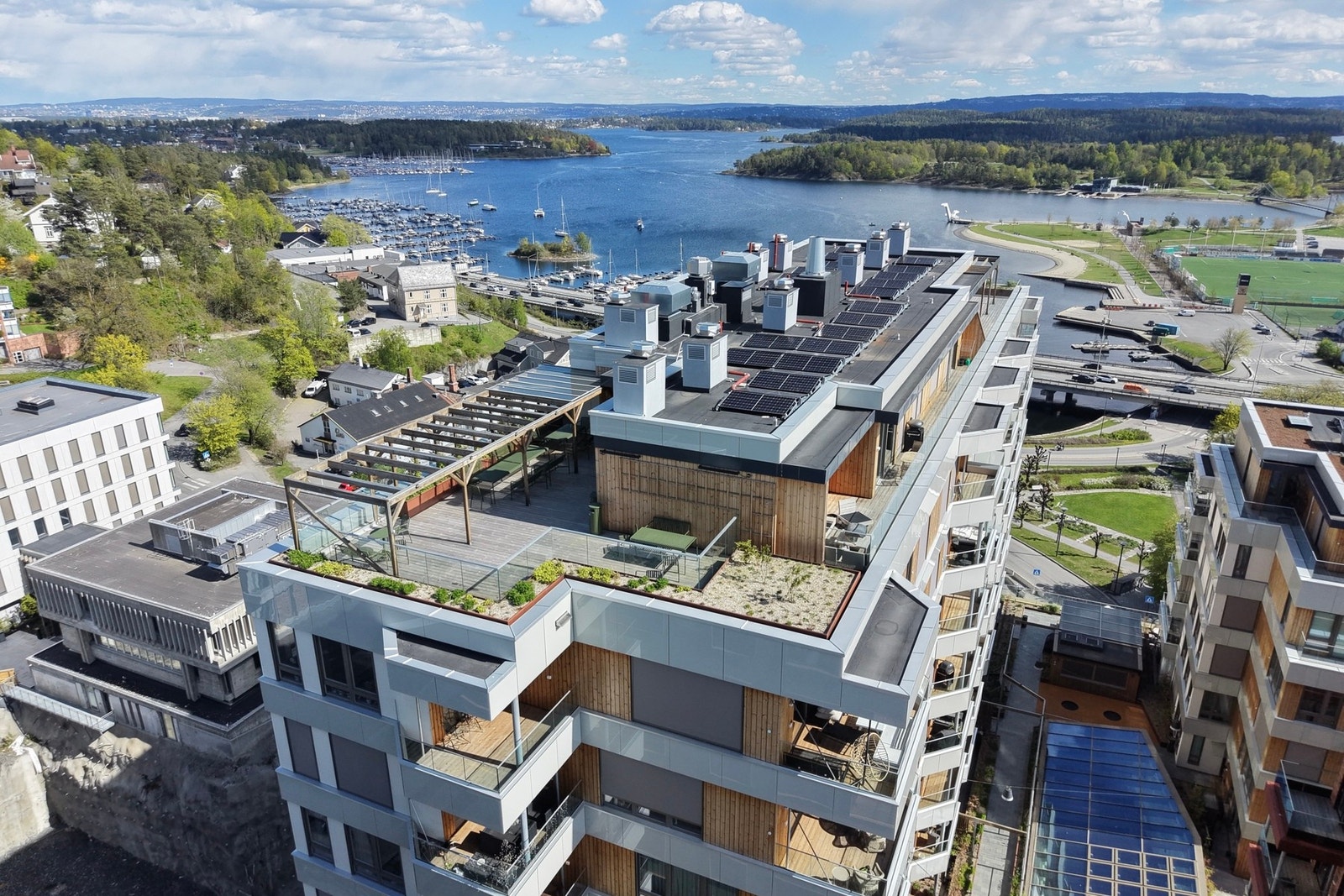 Takterrassen øverst i nabobygget er utstyrt med sittegrupper under flotte pergolaer Galleribilde