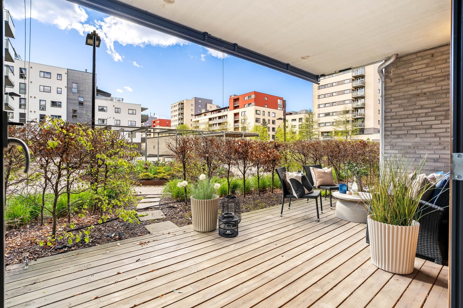 Fra stuen har leiligheten utgang til en stor markterrasse på ca. 14 kvm, med overbygg, skjermende screens og utsyn til frodige fellesarealer. Galleribilde