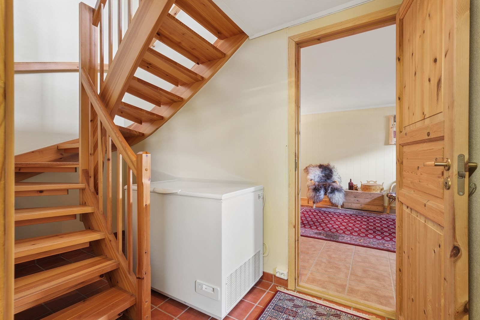 Fra hallen i kjelleren er det adkomst til etasjens øvrige rom. Trappen i lakkert tre binder etasjene sammen. Galleribilde