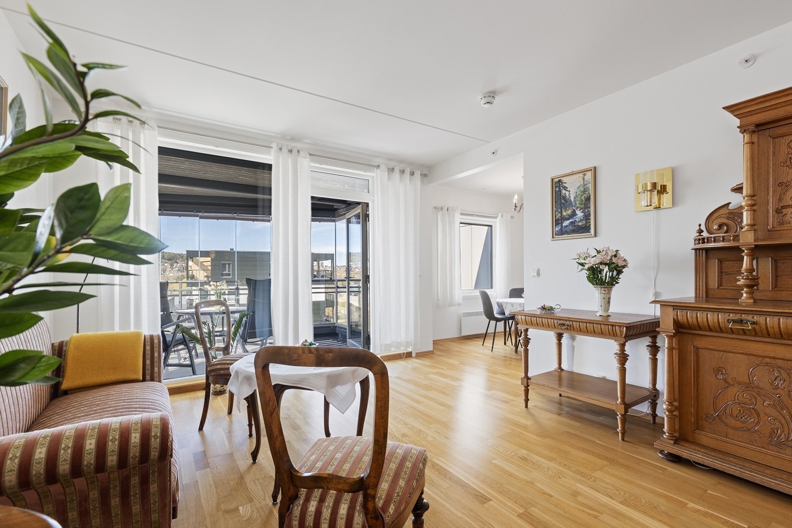 Leiligheten har gjennomgående parkett og en romslig stue med utgang til balkongen, som ble innglasset i 2023. Galleribilde