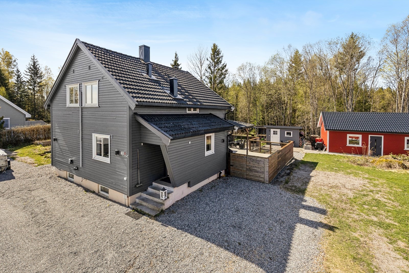 Du ønskes velkommen inn via overbygget inngangsparti i boligens første etasje. Montert el-billader på husvegg. Galleribilde