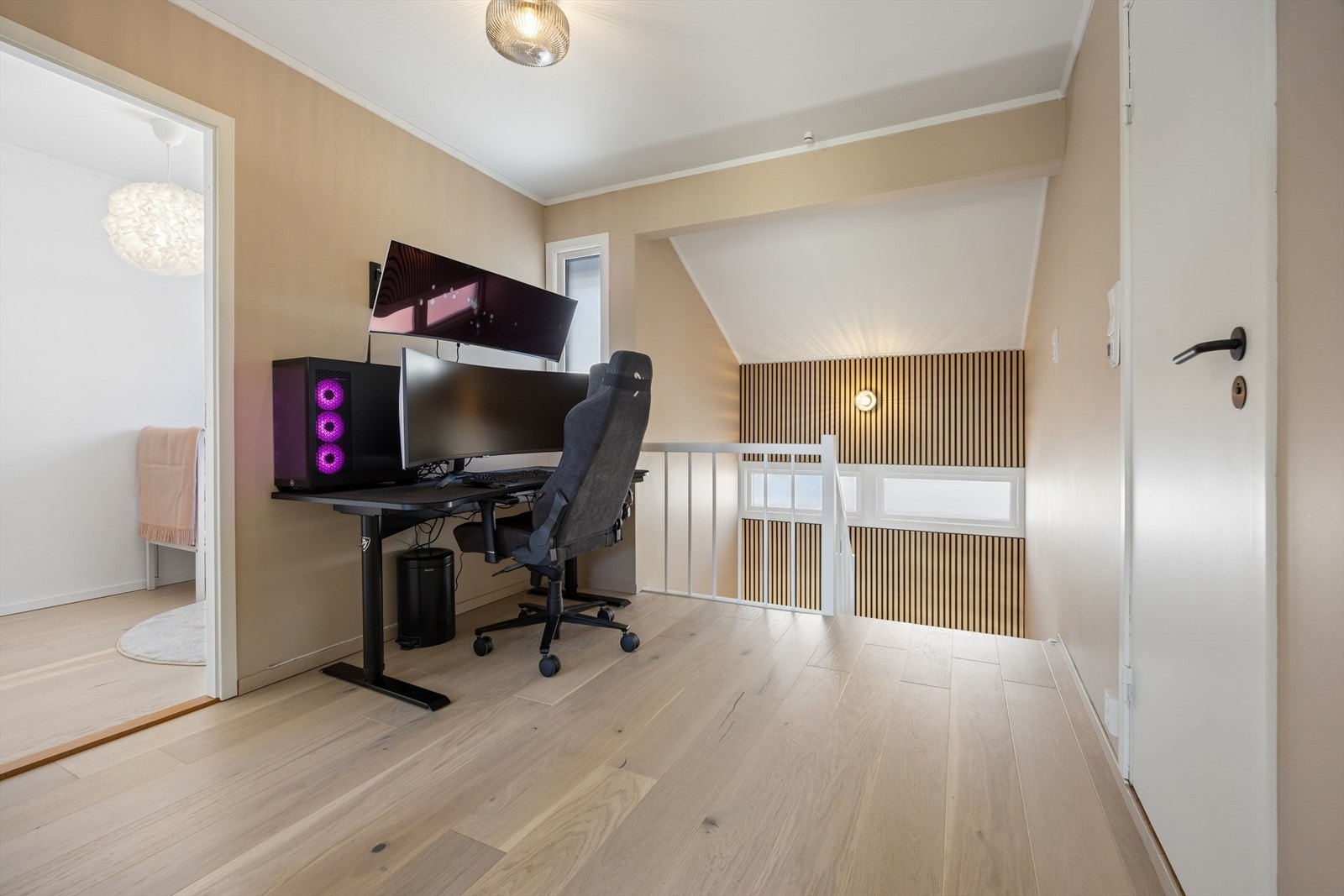 Følger man trappen opp til boligens andre etasje kommer man inn i en romslig gang som i dag er innredet med hjemmekontor. Galleribilde